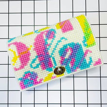 Load image into Gallery viewer, Colorful cross stitch clutch bag on a grid background