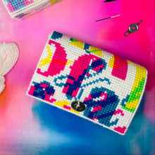 Load image into Gallery viewer, Two cross-stitched pouches with colorful patterns on a multicolored background