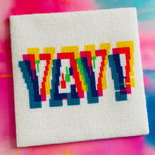 Load image into Gallery viewer, Cross-stitched colorful text on a white fabric background with a multicolored blurred background.