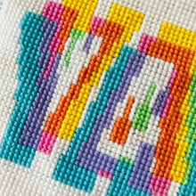 Load image into Gallery viewer, Close-up of a cross-stitched design with colorful geometric shapes on a white fabric background.