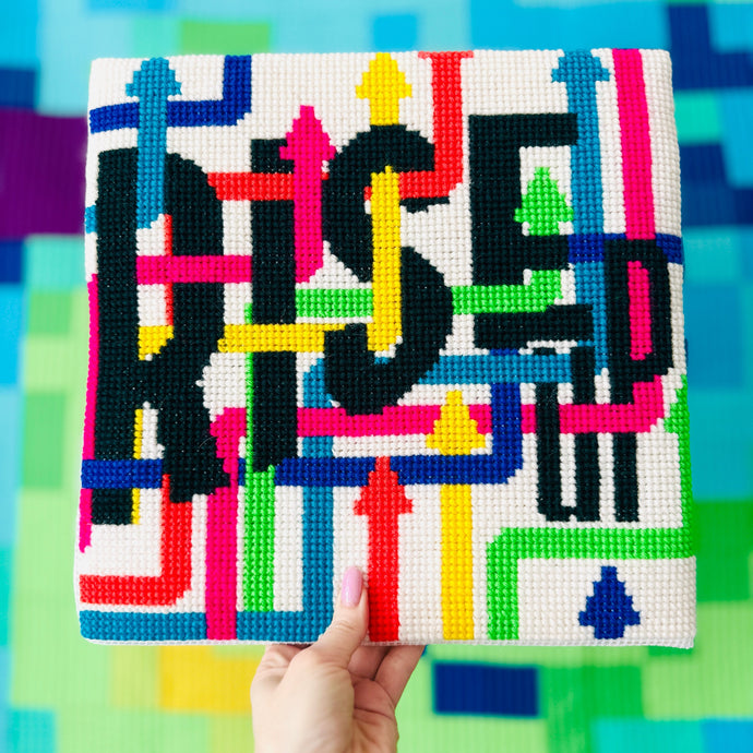 Rise Up Chunky Cross stitch kit - a maze of coloured arrows surrounding the words rise up